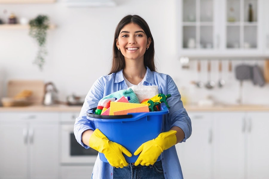 House Cleaner Holding Bucket of Cleaning Supplies