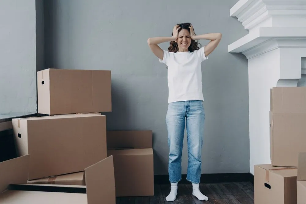 Woman With Moving Boxes Stressed