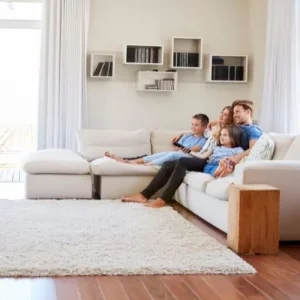 Family watching TV in a clean and organized home